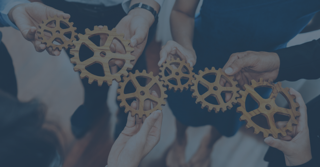 Practical Agility for Enterprises - People holding gears, representing working together
